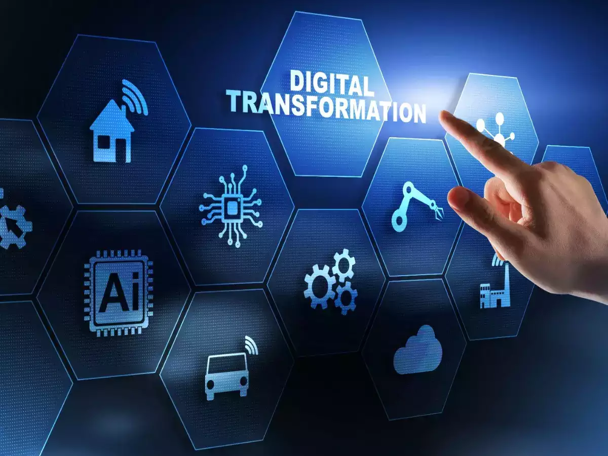 Hand touching the words digital transformation that appear on a touchscreen with technology icons